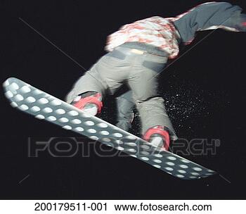 Stock Photography - teenage boy (15-17) 
performing jump 
on snowboard, 
night, rear view. 
fotosearch - search 
stock photos, 
pictures, images, 
and photo clipart