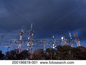 Stock Photography - communication 
masts rising above 
trees, low angle 
view. fotosearch 
- search stock 
photos, pictures, 
images, and photo 
clipart
