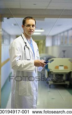 Stock Photography - doctor holding 
pda in hospital 
corridor, portrait. 
fotosearch - search 
stock photos, 
pictures, images, 
and photo clipart