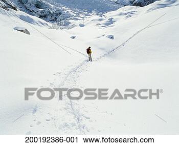 Stock Photography - mature man standing 
in snowshoe path, 
rear view. fotosearch 
- search stock 
photos, pictures, 
images, and photo 
clipart