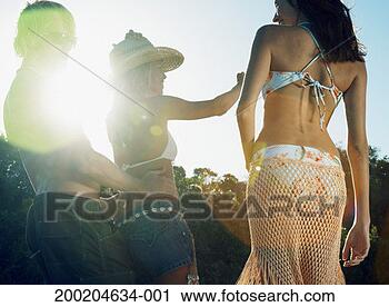 Stock Photography - three young friends 
dancing on beach, 
low angle view 
(sun flare). fotosearch 
- search stock 
photos, pictures, 
images, and photo 
clipart