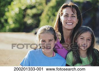 Stock Photography - woman and two 
girls (7-9) outdoors, 
smiling, portrait. 
fotosearch - search 
stock photos, 
pictures, images, 
and photo clipart