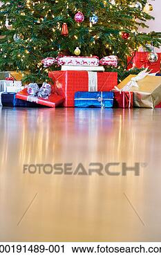 Stock Photography - wrapped presents 
under christmas 
tree, ground view. 
fotosearch - search 
stock photos, 
pictures, images, 
and photo clipart