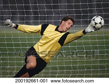 Stock Photography - young male goalie 
reaching for soccer 
ball. fotosearch 
- search stock 
photos, pictures, 
images, and photo 
clipart