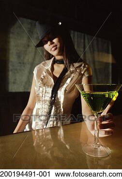 Stock Photography - young woman with 
cocktail in martini 
glass (focus on 
martini glass). 
fotosearch - search 
stock photos, 
pictures, images, 
and photo clipart