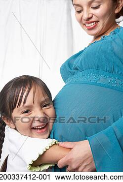 Stock Photography - girl (4-6) hugging 
pregnant young 
mother's stomach, 
smiling, portrait. 
fotosearch - search 
stock photos, 
pictures, images, 
and photo clipart