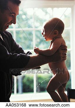Stock Photo - father holding 
nude baby boy 
(3-6 months), 
baby urinating, 
side view. fotosearch 
- search stock 
photos, pictures, 
images, and photo 
clipart