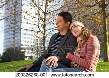 Stock Photography - couple sitting 
in urban park, 
embracing, side 
view, autumn. 
fotosearch - search 
stock photos, 
pictures, images, 
and photo clipart