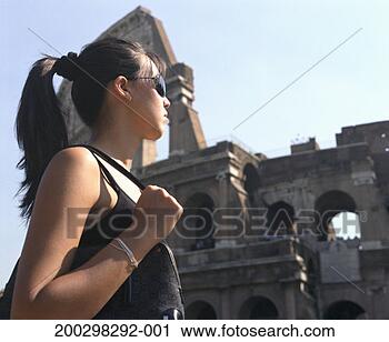 Stock Photography - italy, rome, young 
woman looking 
at colosseum, 
profile, low angle 
view. fotosearch 
- search stock 
photos, pictures, 
images, and photo 
clipart