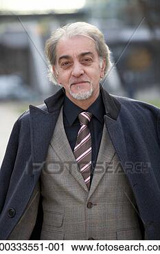 Stock Photography - mature businessman 
with coat around 
shoulders, portrait, 
close-up. fotosearch 
- search stock 
photos, pictures, 
images, and photo 
clipart