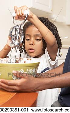 Stock Photography - mother holding 
bowl while son 
(2-4) mixes icing 
with egg beater. 
fotosearch - search 
stock photos, 
pictures, images, 
and photo clipart
