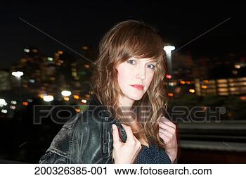 Stock Photography - young woman holding 
collar of jacket, 
close-up, portrait, 
night. fotosearch 
- search stock 
photos, pictures, 
images, and photo 
clipart