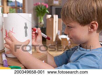 Stock Photography - boy (4-6) drawing 
on polystyrene 
cylinder, side 
view. fotosearch 
- search stock 
photos, pictures, 
images, and photo 
clipart