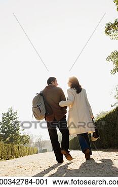 Stock Photography - couple walking 
along pathway 
arm in arm, rear 
view, ground view. 
fotosearch - search 
stock photos, 
pictures, images, 
and photo clipart