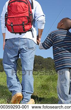 Stock Photography - father and son 
(5-7) holding 
hands, walking 
up hillside, rear 
view. fotosearch 
- search stock 
photos, pictures, 
images, and photo 
clipart