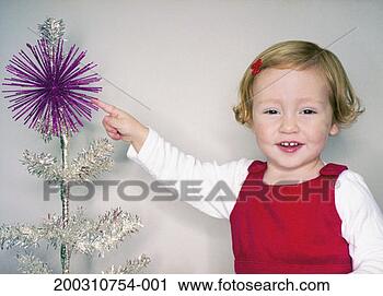 Stock Photography - girl (2-4) pointing 
at christmas tree, 
smiling, portrait. 
fotosearch - search 
stock photos, 
pictures, images, 
and photo clipart