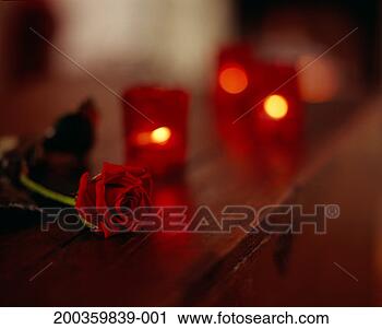 Stock Photography - lit candles and 
single red rose 
on table (focus 
on rose). fotosearch 
- search stock 
photos, pictures, 
images, and photo 
clipart