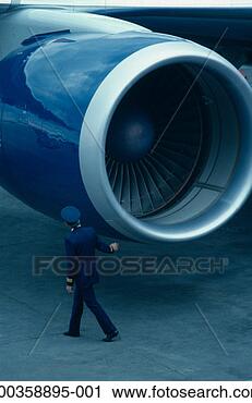 Stock Photography - pilot walking 
past aircraft 
jet engine, rear 
view. fotosearch 
- search stock 
photos, pictures, 
images, and photo 
clipart