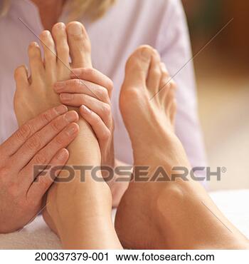Stock Photography - woman getting 
foot massage by 
reflexologist 
(focus on hands 
and feet). fotosearch 
- search stock 
photos, pictures, 
images, and photo 
clipart