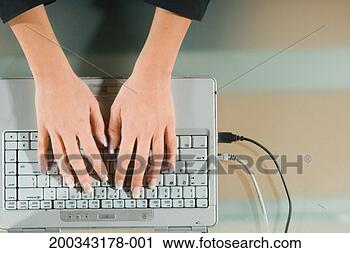Stock Photography - young woman using 
laptop, overhead 
view, close-up 
of hands. fotosearch 
- search stock 
photos, pictures, 
images, and photo 
clipart