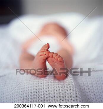 Stock Photography - baby girl (6-9 
months) lying 
in baby seat (focus 
on feet). fotosearch 
- search stock 
photos, pictures, 
images, and photo 
clipart