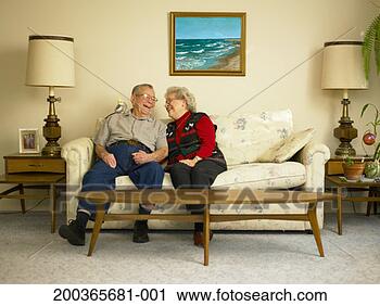 Stock Photography - senior couple 
laughing on sofa, 
bird perched on 
man's shoulder. 
fotosearch - search 
stock photos, 
pictures, images, 
and photo clipart
