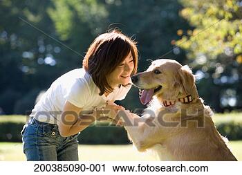 Stock Photography - woman holding 
dogs paws, side 
view. fotosearch 
- search stock 
photos, pictures, 
images, and photo 
clipart