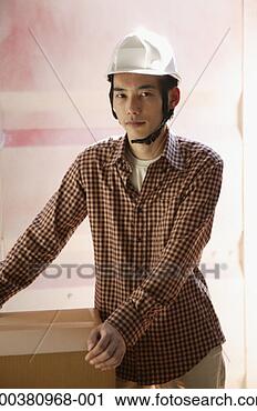 Stock Photography - young man wearing 
helmet, portrait. 
fotosearch - search 
stock photos, 
pictures, images, 
and photo clipart