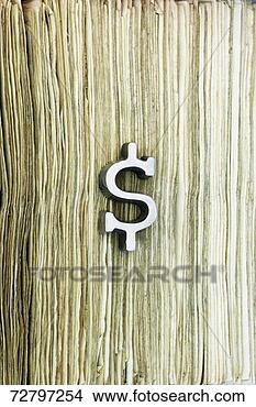 Stock Photo - dollar symbol 
on stack of money, 
close-up. fotosearch 
- search stock 
photos, pictures, 
images, and photo 
clipart