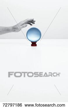 Stock Photo - human hand over 
crystal ball, 
studio shot. fotosearch 
- search stock 
photos, pictures, 
images, and photo 
clipart