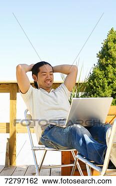 Stock Photo - man sitting with 
laptop on  lap. 
fotosearch - search 
stock photos, 
pictures, images, 
and photo clipart