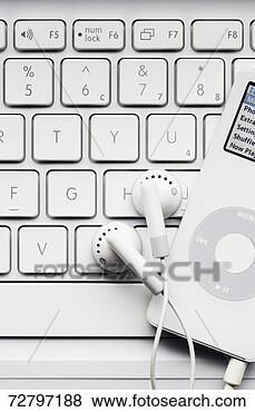 Stock Photo - mp3 player on 
computer keyboard, 
studio shot, close-up, 
overhead view. 
fotosearch - search 
stock photos, 
pictures, images, 
and photo clipart