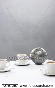 Picture - three coffee cups 
and silver globe 
on table. fotosearch 
- search stock 
photos, pictures, 
images, and photo 
clipart