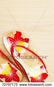 Stock Photo - wood sandals with 
red floral pattern, 
overhead view. 
fotosearch - search 
stock photos, 
pictures, images, 
and photo clipart