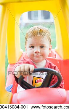 Stock Photography - baby boy (15-18 
months) sitting 
in toy car, portrait. 
fotosearch - search 
stock photos, 
pictures, images, 
and photo clipart