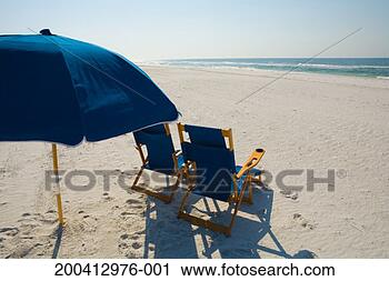 Stock Photography - beach chairs and 
sun umbrella on 
beach, rear view. 
fotosearch - search 
stock photos, 
pictures, images, 
and photo clipart