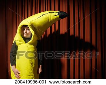 Stock Photography - boy (5-7) by stage 
curtain wearing 
banana costume, 
portrait, close-up. 
fotosearch - search 
stock photos, 
pictures, images, 
and photo clipart
