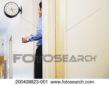 Stock Photography - businessman holding 
cup of coffee, 
standing in office 
doorway. fotosearch 
- search stock 
photos, pictures, 
images, and photo 
clipart