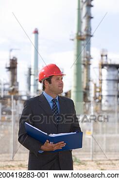 Stock Photography - businessman wearing 
hardhat holding 
documents. fotosearch 
- search stock 
photos, pictures, 
images, and photo 
clipart