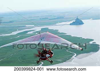 Stock Photography - france, normandy, 
ultralight over 
mont saint-michel, 
aerial view. fotosearch 
- search stock 
photos, pictures, 
images, and photo 
clipart
