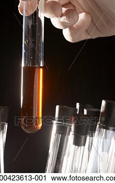 Stock Photography - lab tech holding 
test tube with 
liquid. fotosearch 
- search stock 
photos, pictures, 
images, and photo 
clipart