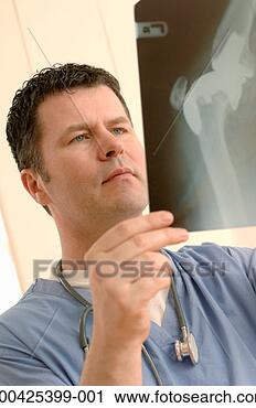 Stock Photography - mature male doctor 
examining x-ray, 
close-up. fotosearch 
- search stock 
photos, pictures, 
images, and photo 
clipart