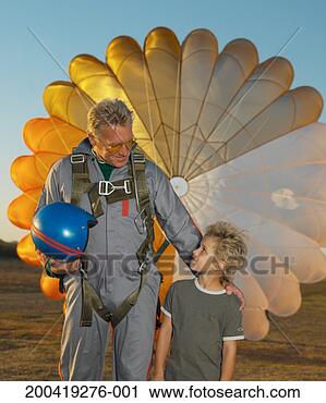 Stock Photography - mature man wearing 
parachute, hand 
on boy's (5-7) 
shoulder. fotosearch 
- search stock 
photos, pictures, 
images, and photo 
clipart