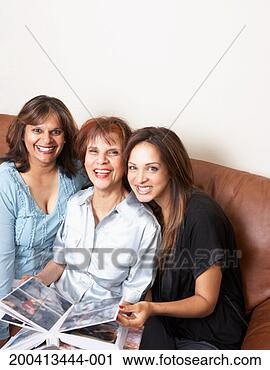 Stock Photography - mother, daughter 
and grandmother 
looking at photo 
album, portrait. 
fotosearch - search 
stock photos, 
pictures, images, 
and photo clipart