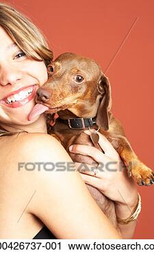 Stock Photography - teenage girl (12-14) 
holding dog licking 
her face. fotosearch 
- search stock 
photos, pictures, 
images, and photo 
clipart