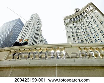 Stock Photography - two business executives 
standing on bridge. 
fotosearch - search 
stock photos, 
pictures, images, 
and photo clipart