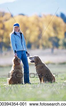 Stock Photography - woman with plastic 
disc and dogs 
in field, autumn. 
fotosearch - search 
stock photos, 
pictures, images, 
and photo clipart