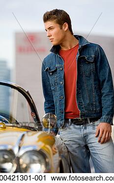 Stock Photography - young man leaning 
on car and looking 
away. fotosearch 
- search stock 
photos, pictures, 
images, and photo 
clipart
