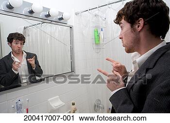 Stock Photography - young man pointing
at reflection
in mirror, side
view, close-up.
fotosearch - search
stock photos,
pictures, images,
and photo clipart