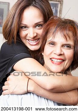 Stock Photography - young woman hugging 
grandmother, smiling, 
portrait. fotosearch 
- search stock 
photos, pictures, 
images, and photo 
clipart